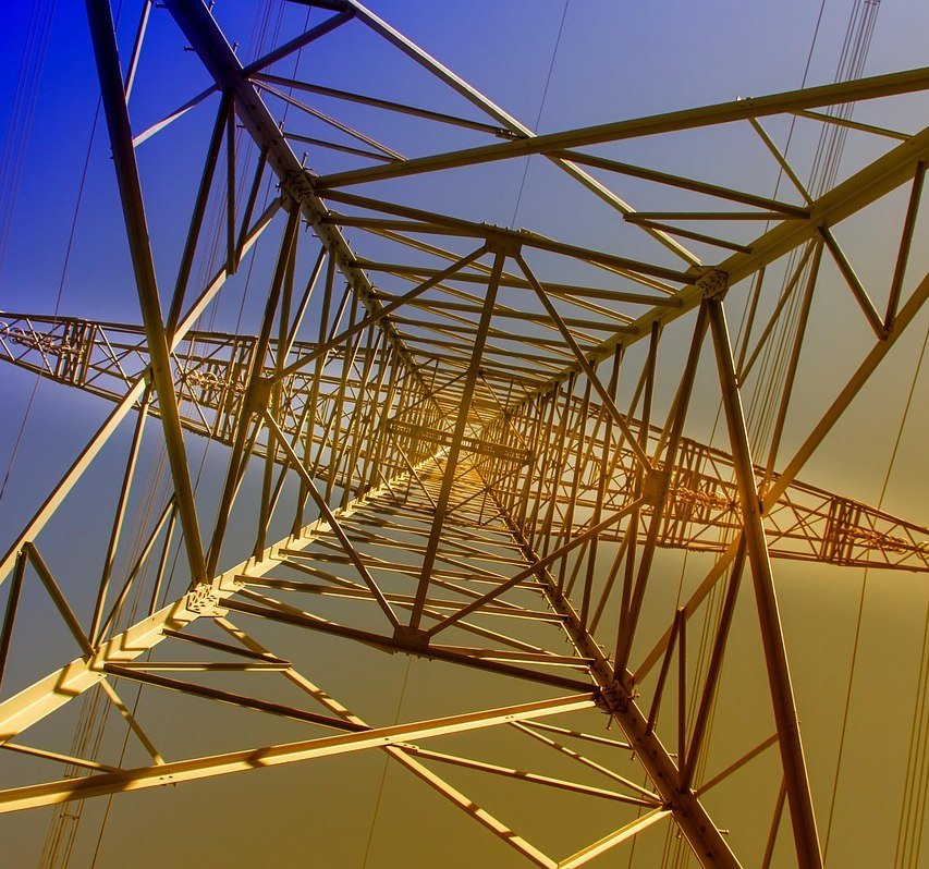 High-voltage transmission towers at dusk